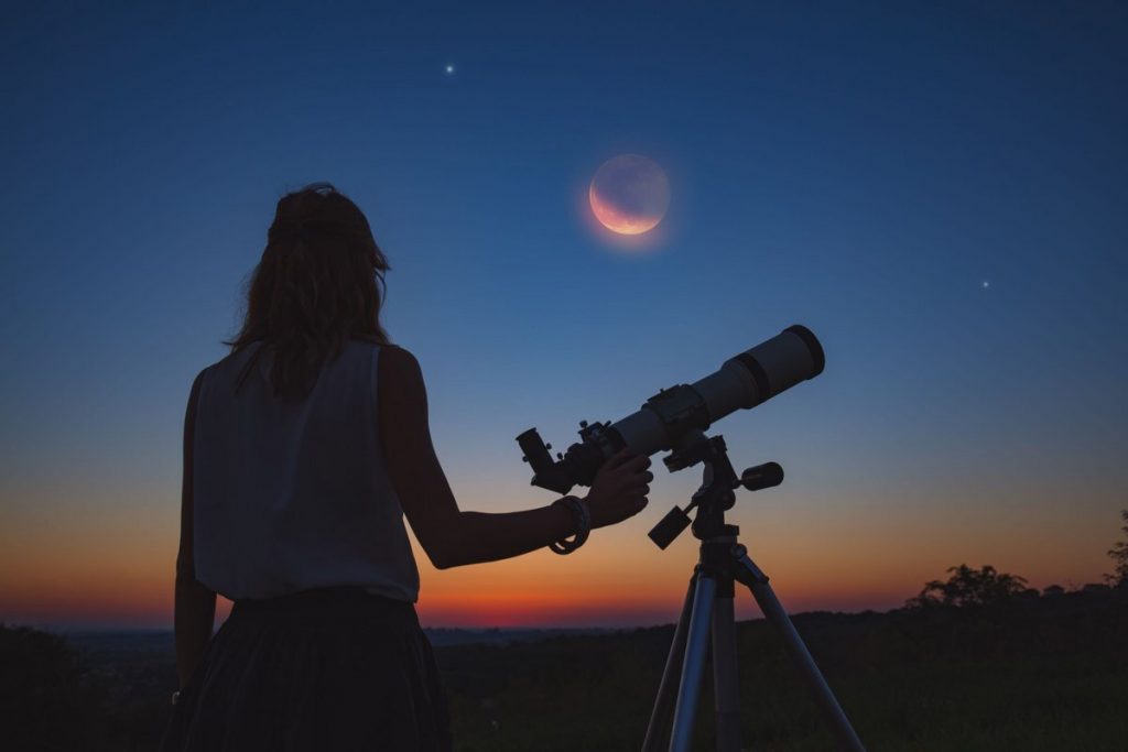 Photo d'une femme utilisant un télescope 